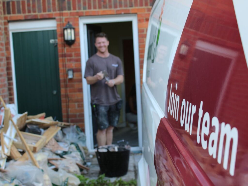 Luke Mead, a multi-skilled plumber, working on a Selwood Housing property with a Selwood Housing van.