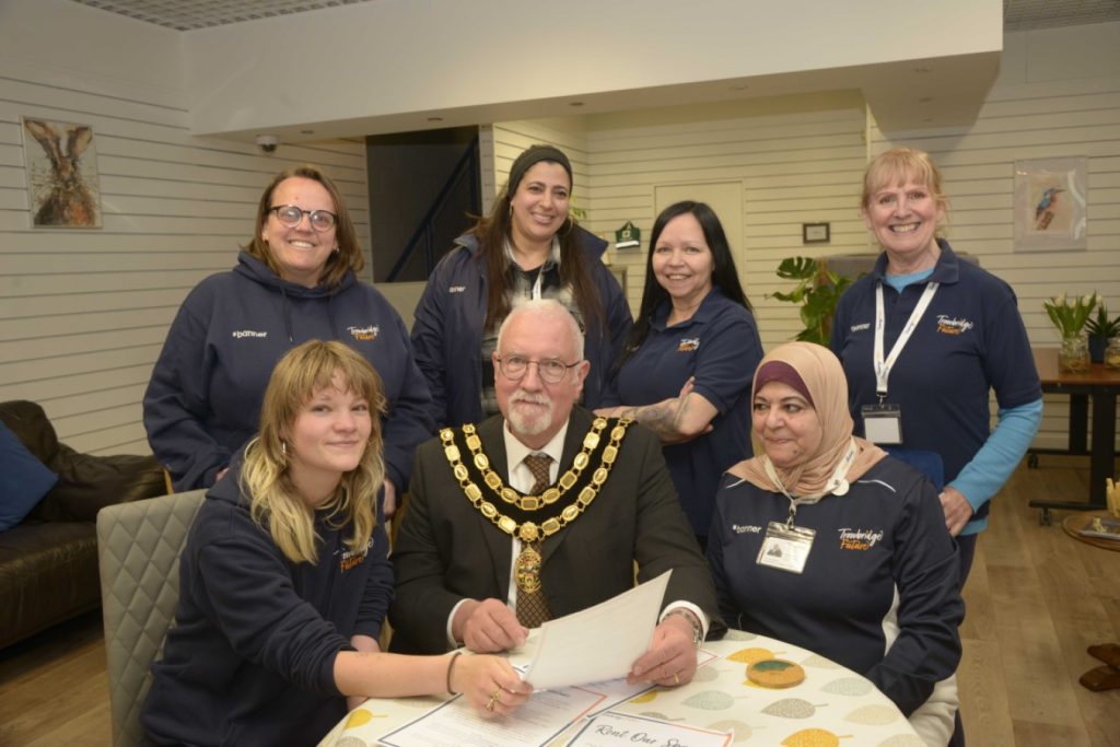 Trowbridge Mayor Cllr Stephen Cooper studies the work that is undertaken at Trowbridge Community Hub. 