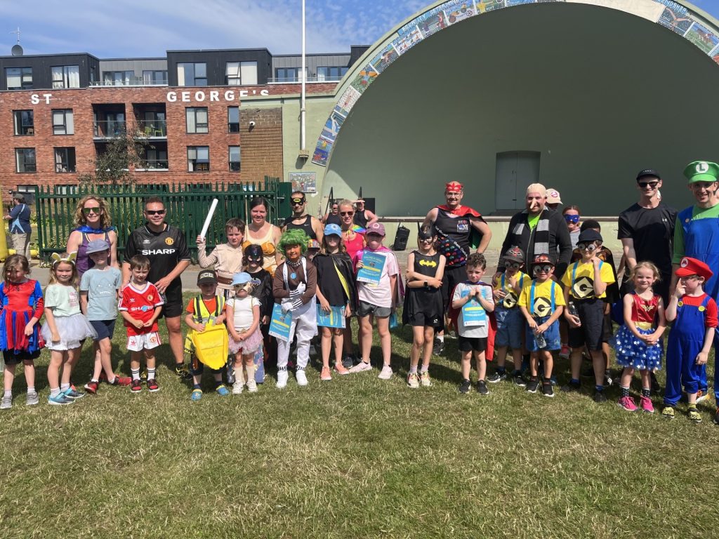 Trowbridge Heroes and villains fun run group of runners in fancy dress