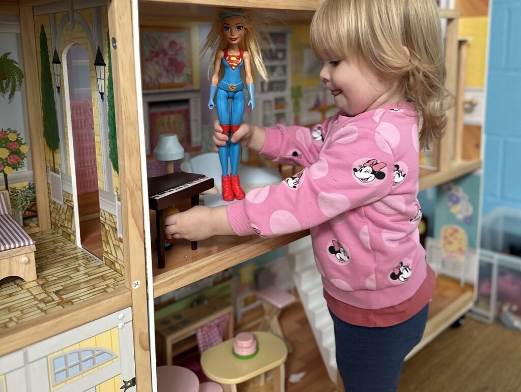 A happy child playing with a new toy provided by Bowerhill Baby and Toddler group, thanks to Selwood Housing's Stronger Communities Fund.