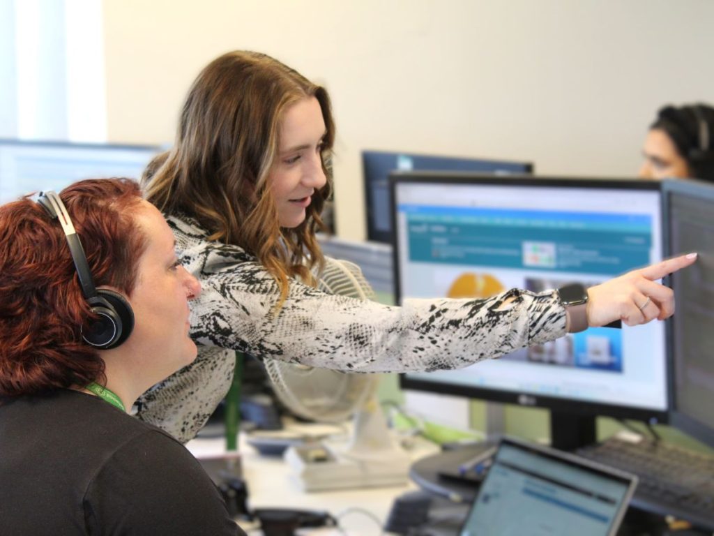 Zoe Ridley, one of Selwood Housing's customer complaints specialists, assisting a team member