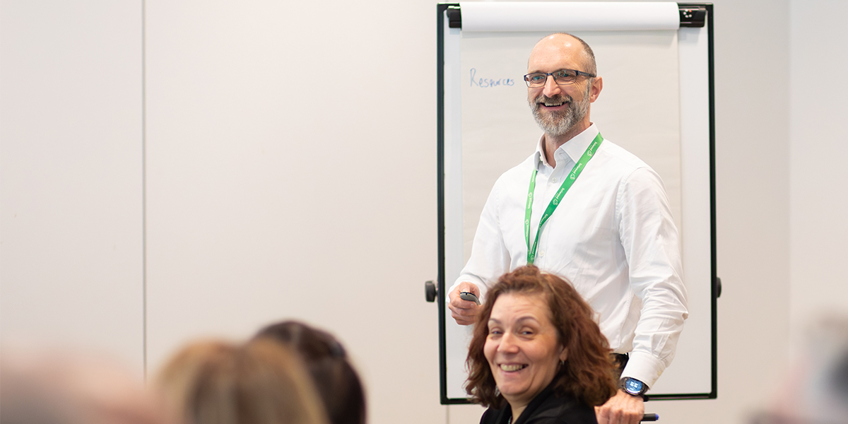 Selwood Housing CEO presenting at staff meeting in front of flip chart