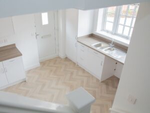 Looking down the stairs into kitchen and front door in a new shared ownership home in Trowbridge