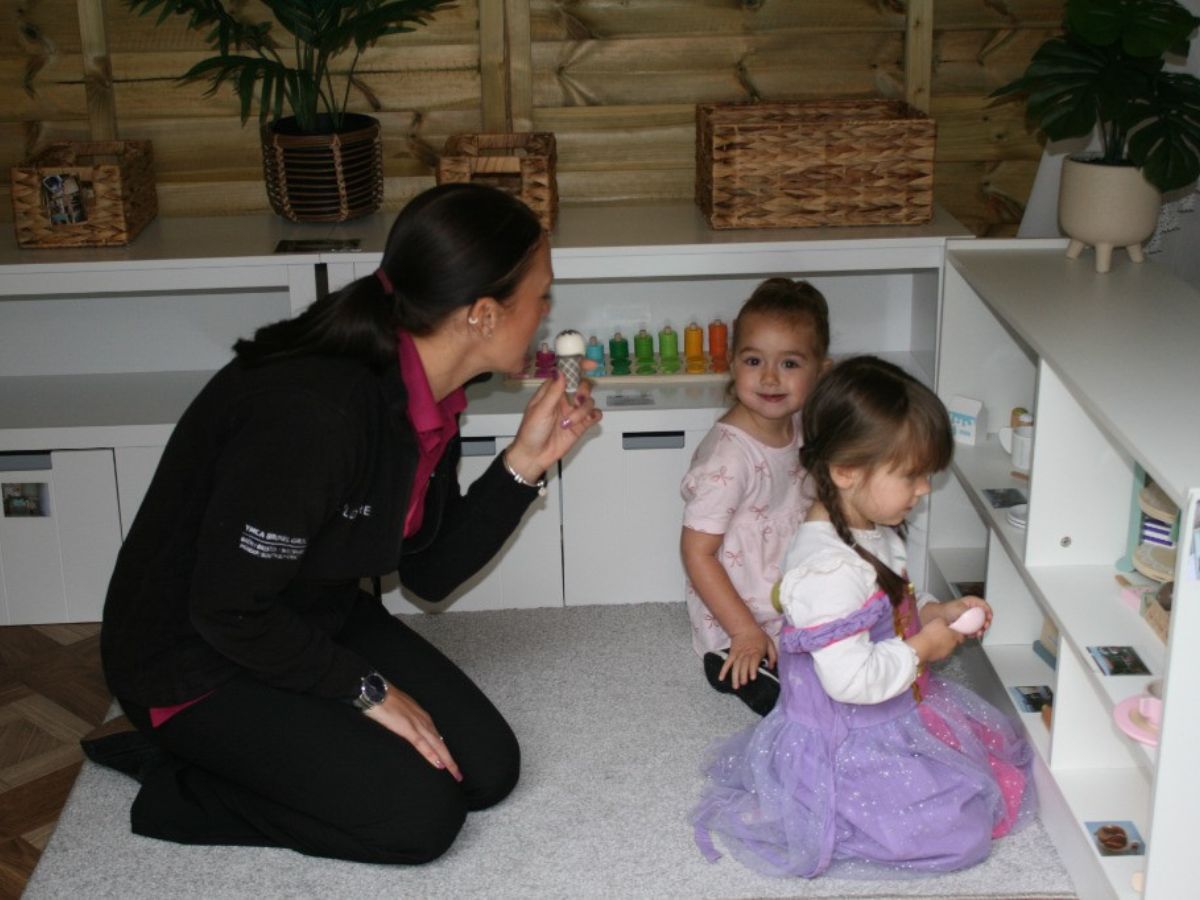 Nursery manager and children playing in new montessori style play area