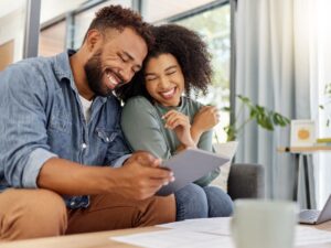 Two people smiling looking at tablet