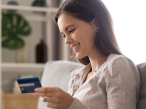 Smiling woman using debit card