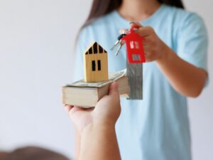 Two people swapping home figures and keys